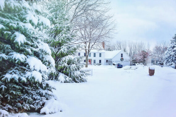Snow-covered landscape with residential home in Lancaster County, Pennsylvania, depicting the need for reliable emergency HVAC and plumbing services during winter.
