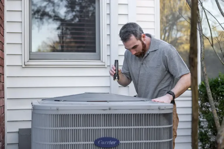 air-conditioning-repair-downington-technician-inspecting-carrier-ac-unit-outdoors