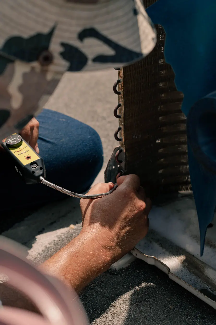 air-conditioning-repair-downington-technician-using-leak-detector-on-ac-coil
